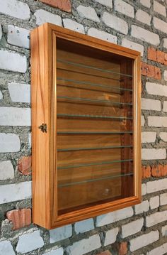 a wooden window on the side of a brick wall