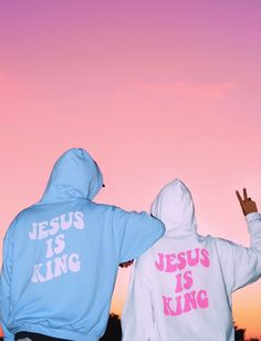 two people wearing sweatshirts with the words jesus is king on them