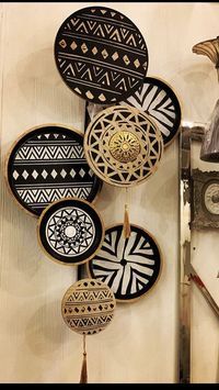 a group of black and white plates hanging on a wall