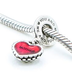 Authentic PANDORA Piece of My Heart Mother Mother Sterling Silver Dangle Charm With Red Enamel Core 790950EN27 - Retired. Generally, this charm consists of two heart dangles that are meant to be shared between a mother and a daughter. Both charms are engraved with "You and Me", "Me and You" and both enamel hearts are engraved, one with the word "mother" and the other with the word "daughter". In this case, both hearts are engraved with the word "mother." A very special gift to give to the two wo Valentine's Day Double Heart Charms, Red Charms For Valentine's Day, Red Charms For Valentine's Day Gift, Red Valentine's Day Gift Charms, Pandora Store, Pandora Bracelet Designs, Pandora Heart, Mother Mother, Me Me