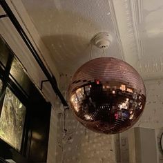 a shiny disco ball hanging from the ceiling