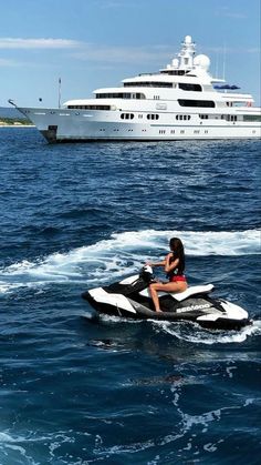 a woman riding on the back of a jet ski