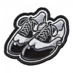 a black and white patch with two shoes on it