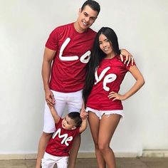 a man, woman and child wearing matching red shirts