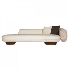 a white couch with two pillows on it's back and the seat upholstered