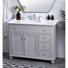 a white sink sitting under a mirror in a bathroom