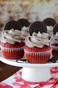 red velvet cupcakes with oreo cookies and cream frosting on a cake plate