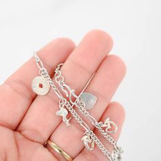 Discover charm and elegance with our 925 Sterling Silver S Curb Link Chain and Multiple Charms Bracelet. Adorned with delightful Chinese coin, Snoopy, heart, and apple charms, this bracelet exudes personality and style. Perfect for adding a playful touch to any outfit or as a meaningful gift for someone special. Elevate your look with this unique and versatile piece today.Bracelet length: 6inChain style: Chain S linkWeight: 7gFor more of our jewelry products, please visit our shop 777jewelryLA F Sterling Silver Charm Bracelet With Heart Charm, Sterling Silver Charm Bracelet With Heart Dangle, Sterling Silver Charm Bracelet With Heart Charm For Everyday, Everyday Sterling Silver Charm Bracelet With Heart, Sterling Silver Bracelets With Dangle Heart Charm, Sterling Silver Dangle Bracelets With Heart Charm, Silver Heart Bracelets With Dangling Charms, Sterling Silver Bracelet With Dangling Charms, Snoopy Heart