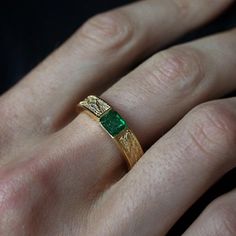 This stylish textured Emerald Dragon Ring was inspired by dragon scales. Handcrafted in 14K gold. This ring features a natural one-of-a-kind deep green emerald. Materials: 14K gold Natural 4.8x5.4mm natural emerald. Approx. 0.7ct Solid band 5mm bandwidth ** Tippy Taste Men's are made-to-order. Please allow 2-3 week turnaround time. This ring is not resizable, please ensure your ring size before ordering. Shipping:Domestic: Free standard shipping within the U.S.International: Free standard shippi Man Emerald Ring, Men’s Wedding Band With Emerald, Mens Gemstone Ring, Green Wedding Ring Men, Emerald Engagement Ring Men, Emerald Wedding Rings Men, Men Emerald Ring, Men’s Emerald Ring, Green Wedding Rings For Men