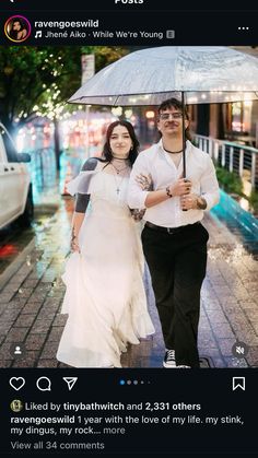 a man and woman walking down the street under an umbrella in the rain, holding hands