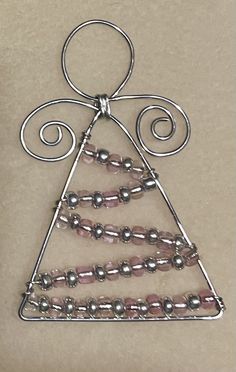 a wire christmas tree ornament with pink beads