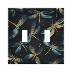 a light switch cover with blue dragonflies on black and gold foiled paper background