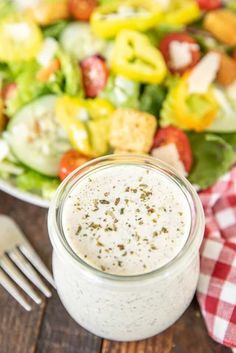 a salad with dressing in a glass jar