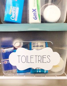 two plastic containers with toothpaste and other items in them, labeled toletries