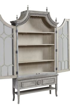 an old fashioned china cabinet with glass doors and drawers on the front, in white