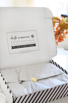 an open white box with black and white stripes on it sitting on top of a table