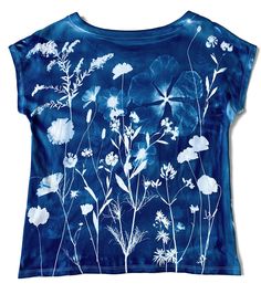 a blue shirt with white flowers on it