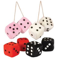 four different colored dices with black dots hanging from the top and one is red