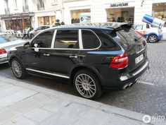 a black car parked on the side of a street