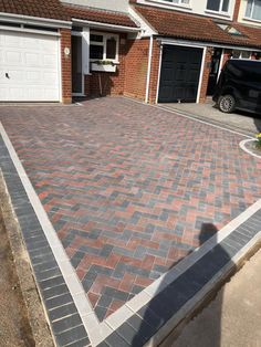 a brick driveway in front of a house