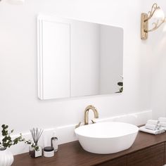 a bathroom sink sitting under a large mirror