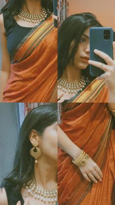 a woman in an orange sari taking a selfie with her cell phone while wearing pearls