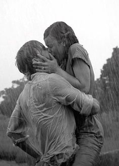 two people in the rain hugging each other