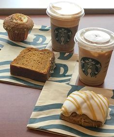 starbucks coffees and pastries are on the table next to some paper napkins