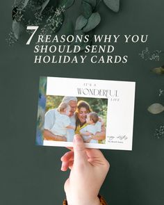 someone holding up a card with the words 7 reason why you should send holiday cards