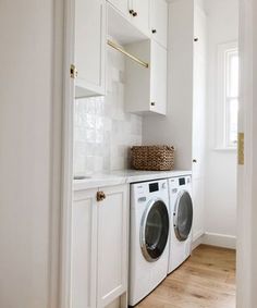 a washer and dryer in a white laundry room