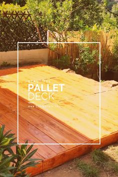 a wooden deck in the middle of a garden with trees and bushes behind it that reads, pallet deck