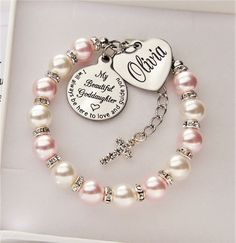 This beautiful Swarovski pearl bracelet would make a stunning gift and keepsake for your special Goddaughter either on a Special day or just to show how much she means to you. The bracelet is made using 8mm swarovski white and rosaline pink pearl (for sizes under 6 inch 6mm pearls will be used ) The charms are stainless steel , please leave the engraving details you require ie.. Name in the box on the listing. Please choose the size you require from the drop down box to order. Your bracelet will Adjustable Pearl Bracelet For Wedding On Valentine's Day, Valentine's Day Gift Pearl Bracelet, Personalized Pink Spiritual Charm Bracelet, Pink Round Rosary Bracelet Gift, Personalized Rosary Bracelet For Birthday And Mother's Day, Personalized White Pearl Bracelet For Baptism, Personalized Pink Rosary Bracelet For Baptism, Elegant Personalized Rosary Bracelet As Gift, Personalized Pink Pearl Bracelet For Birthday