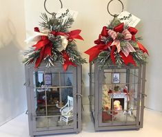 two metal lanterns with christmas decorations on them