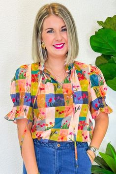 This cheerful gingham print, sprinkled with playful floral tulips, is just the thing to brighten up any day. Whether you're headed to a sunny picnic, a lively brunch with friends, or a casual day out, this top pairs perfectly with your favorite denim for a look that's effortlessly stylish. The button-down front adds a touch of vintage charm, making it a versatile piece that will keep your outfits fresh and fun all season long. PRODUCT FIT - TRUE TO SIZE MODEL DETAILS - BRENNA IS WEARING A SIZE S Summer Gingham Blouse For Picnic, Summer Plaid Blouse For Picnic, Playful Floral Print Blouse For Spring, Cute Spring Tops For Day Out, Trendy Tops For Summer Garden Party, Ditsy Floral Print Short Sleeve Tops For Garden Party, Summer Plaid Blouse For Day Out, Short Sleeve Ditsy Floral Tops For Garden Party, Playful Spring Printed Blouse