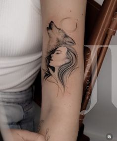 a woman with a wolf tattoo on her arm