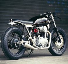 a black and white motorcycle parked in front of a building