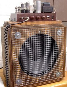 an old fashioned speaker sitting on top of a wooden table