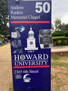 a sign for howard university in front of a park with trees and bushes around it