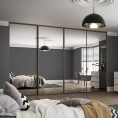 a bedroom with blue walls and mirrored closet doors