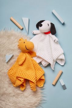 two knitted animals laying next to each other