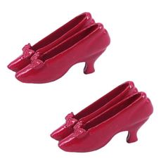 two red plastic shoes with bows on them