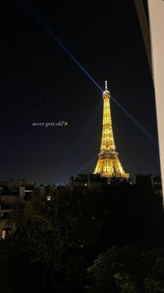 the eiffel tower is lit up at night