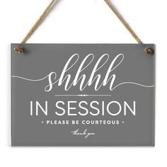 a sign that says shhlh in session please be courteouss on it