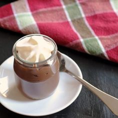 there is a cup of hot chocolate with whipped cream in it on the saucer