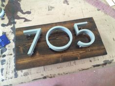 a wooden sign with the number seventy on it