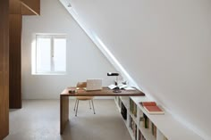 an attic office with bookshelves and desk