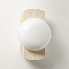 an egg is sitting on top of a marble block and it's white color