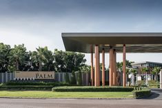 the entrance to palm is surrounded by tall pillars and large columns, with trees in the background