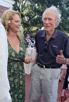 an older man and woman standing next to each other