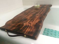 a wooden tray sitting on top of a bath tub